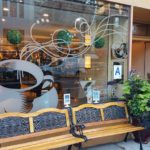 window graphic outside cafe showing coffee mug with warm air rising