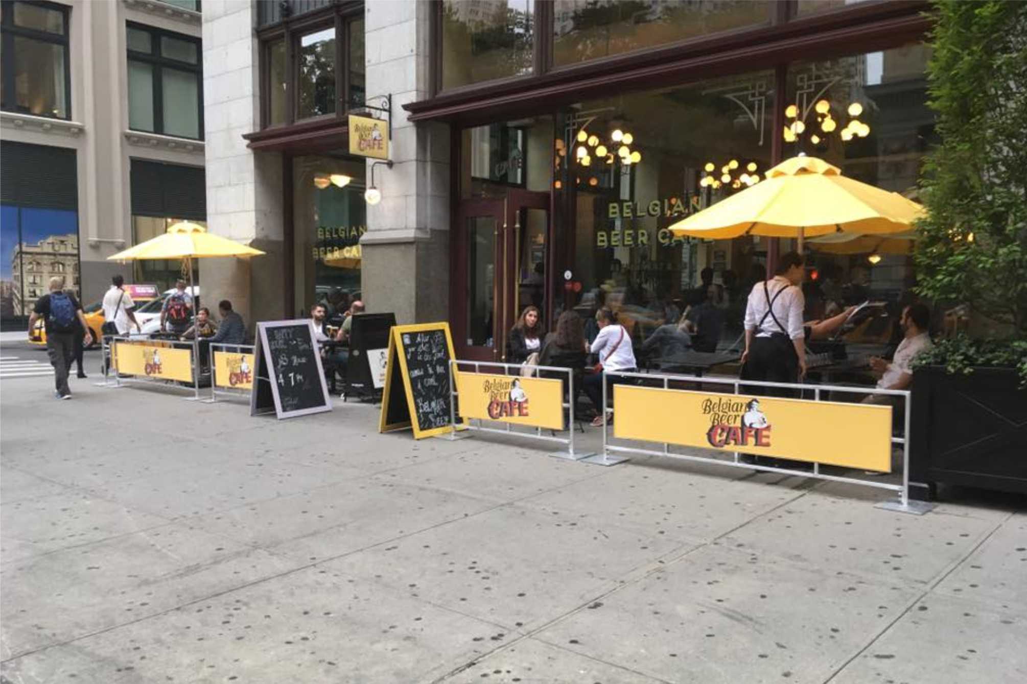 Yellow sidewalk cafe barriers outside belgian beef cafe