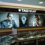 Large format printing for TAG Heuer brand with photos of male and female model and watches