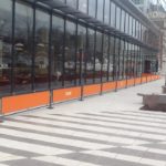 orange sidewalk barriers outside restaurant