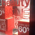Window lettering "beauty sale" in red on store window